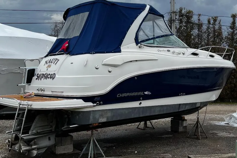 Slide: The Image of 2009 Chaparral Signature 280 boat on stands, featuring blue and white exterior. - 41