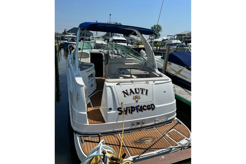 Slide: The Image of 2009 Chaparral Signature 280 boat docked, featuring a playful name on the stern. - 6