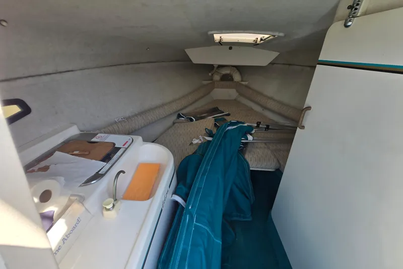 Slide: The Image of Interior cabin of 1992 Wellcraft Eclipse 233 boat with compact amenities and storage. - 2