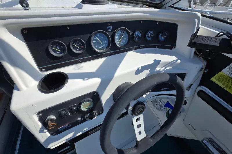 Slide: The Image of 1992 Wellcraft Eclipse 233 dashboard with gauges and steering wheel. - 5