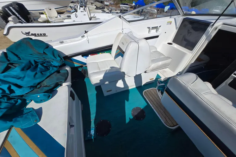 Slide: The Image of 1992 Wellcraft Eclipse 233 boat interior with white seating and teal accents. - 9