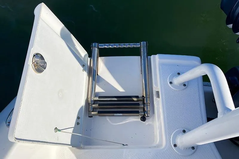 Slide: The Image of 2019 Robalo R207 Dual Console boat ladder and hatch on deck. - 15