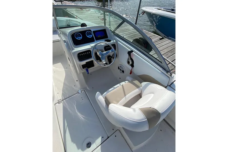 Slide: The Image of 2019 Robalo R207 Dual Console boat interior with steering wheel and dashboard controls. - 3