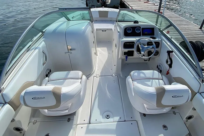 Slide: The Image of 2019 Robalo R207 Dual Console boat interior with white seating and steering wheel. - 5