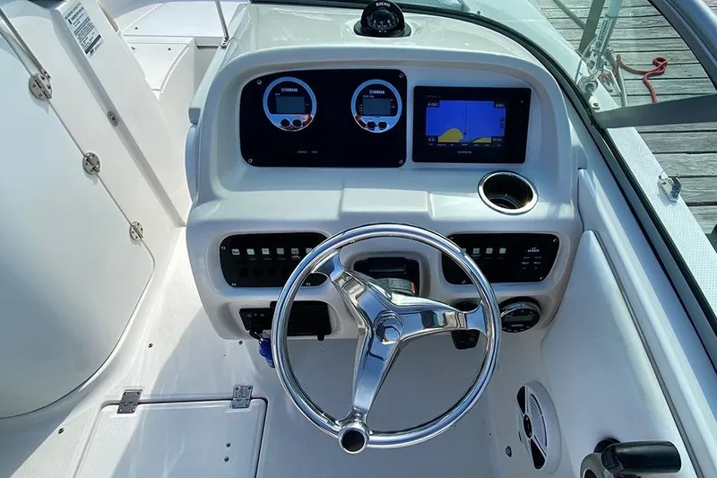 Slide: The Image of 2019 Robalo R207 Dual Console dashboard with steering wheel and navigation instruments. - 6