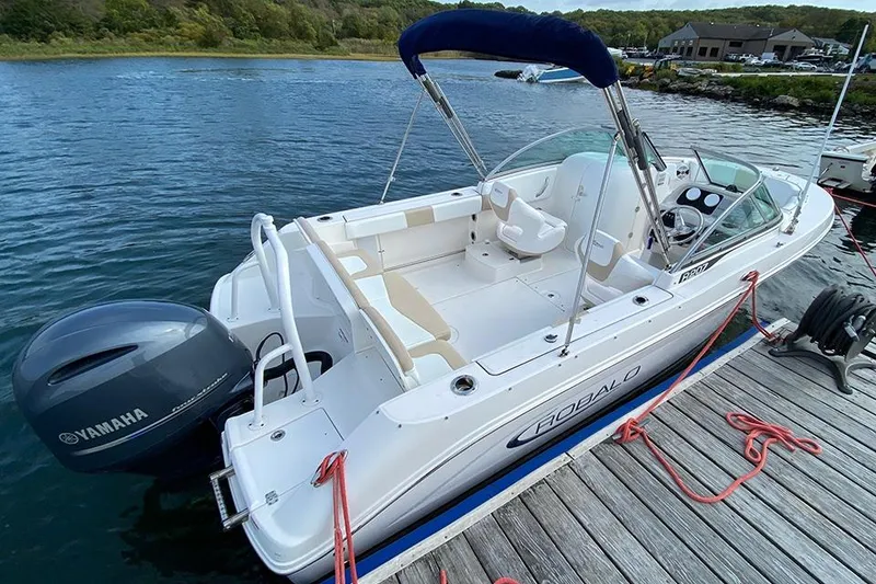 Slide: The Image of 2019 Robalo R207 Dual Console boat docked with Yamaha outboard motor. - 8