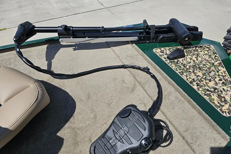 Slide: The Image of 2026 Tracker Bass Tracker Classic Limited boat deck with trolling motor and camouflage detail. - 11