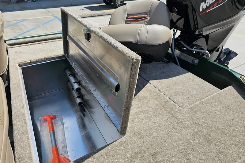 Slide: The Image of 2026 Tracker Bass Tracker Classic Limited boat storage compartment with tools and seating. - 6