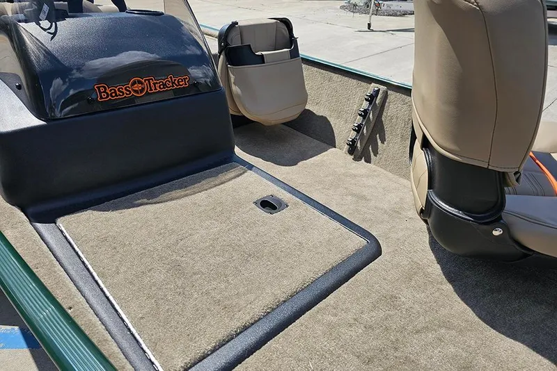 Slide: The Image of 2026 Tracker Bass Tracker Classic Limited boat interior with beige seats and carpeted flooring. - 9