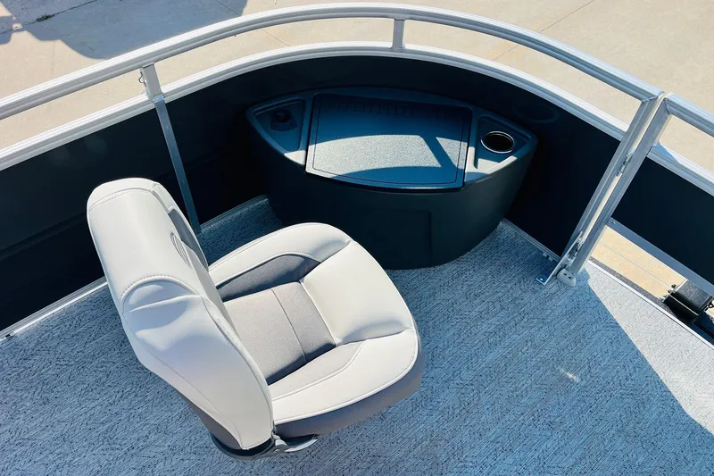 Slide: The Image of 2026 Sun Tracker Fishin' Barge 22 DLX boat interior with seating and storage. - 12