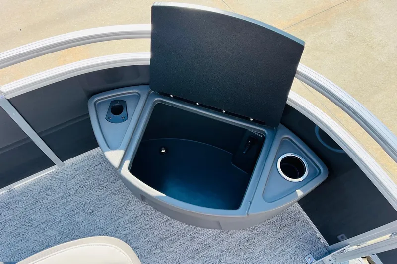 Slide: The Image of 2026 Sun Tracker Fishin' Barge 22 DLX boat storage compartment with cup holder. - 13