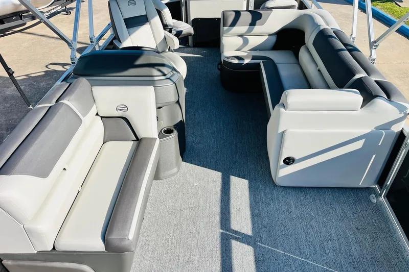 Slide: The Image of 2026 Sun Tracker Fishin' Barge 22 DLX interior with spacious seating and modern design. - 17