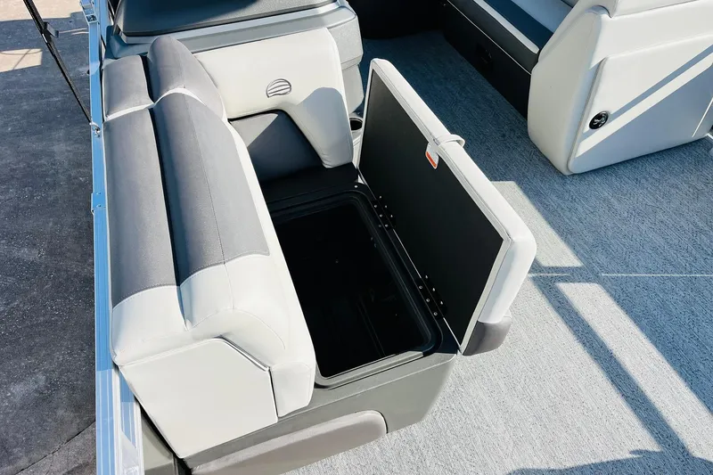 Slide: The Image of 2026 Sun Tracker Fishin' Barge 22 DLX with open storage compartment on deck. - 19