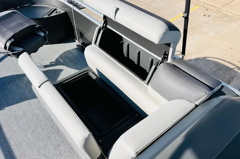 Slide: The Image of 2026 Sun Tracker Fishin' Barge 22 DLX interior with open storage compartments. - 21
