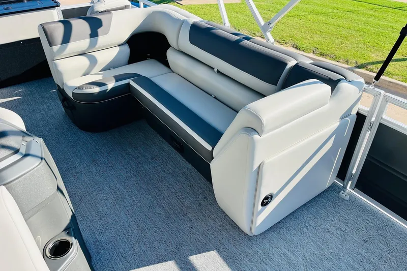 Slide: The Image of 2026 Sun Tracker Fishin' Barge 22 DLX interior with plush seating and modern design. - 22