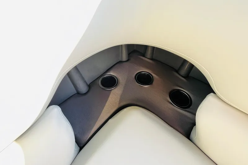 Slide: The Image of 2026 Sun Tracker Fishin' Barge 22 DLX boat seating with integrated cup holders. - 30