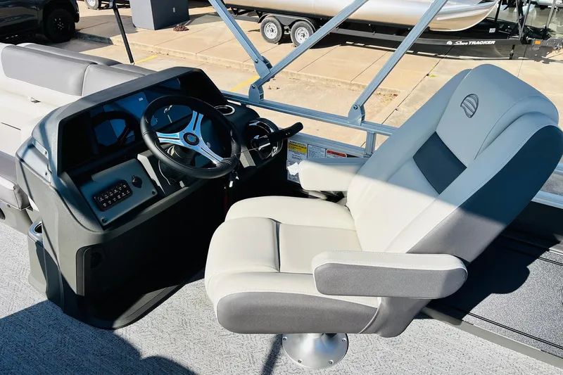 Slide: The Image of 2026 Sun Tracker Fishin' Barge 22 DLX helm with comfortable captain's chair and steering wheel. - 31