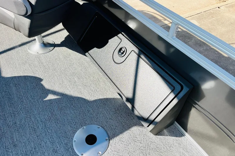 Slide: The Image of Interior of 2026 Sun Tracker Fishin' Barge 22 DLX with storage compartment. - 37