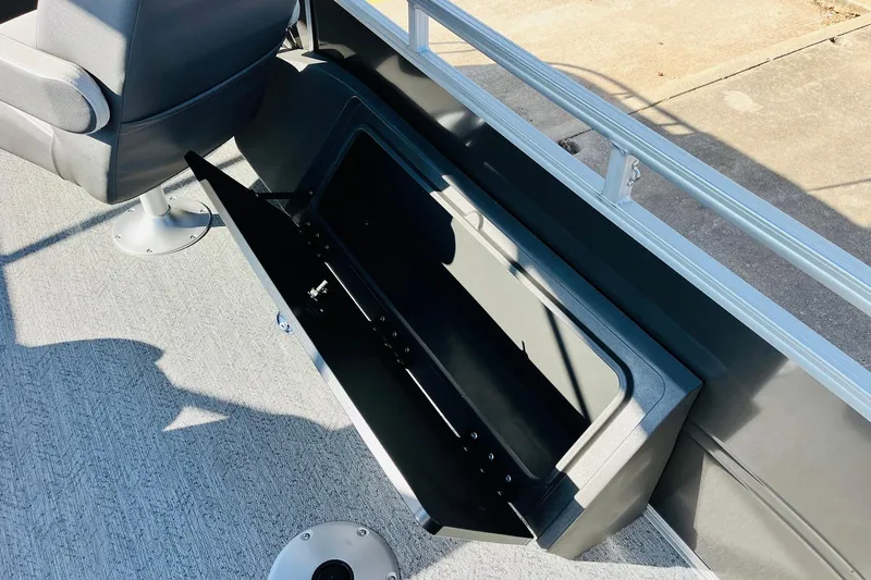 Slide: The Image of 2026 Sun Tracker Fishin' Barge 22 DLX interior storage compartment with seating. - 38
