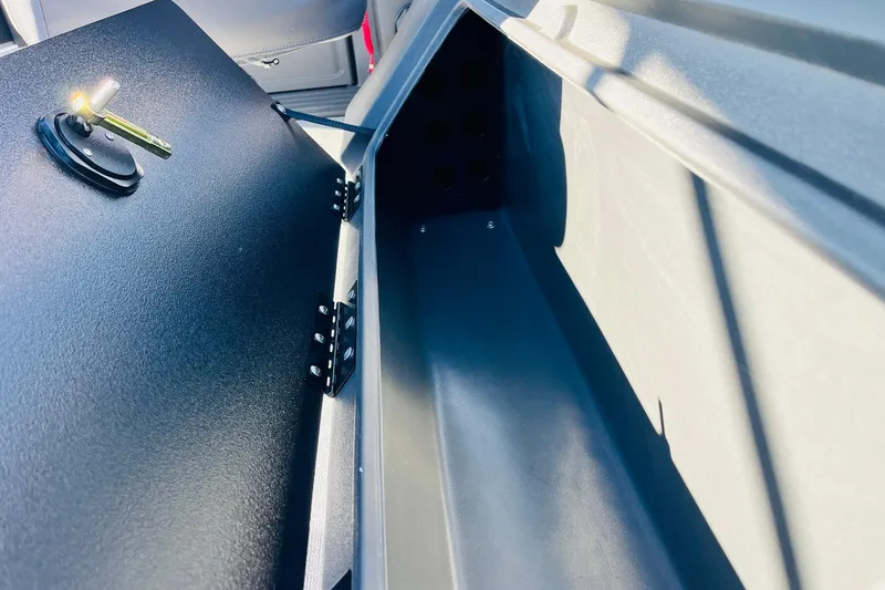 Slide: The Image of 2026 Sun Tracker Fishin' Barge 22 DLX storage compartment with interior light. - 39