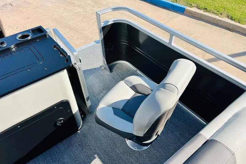 Slide: The Image of 2026 Sun Tracker Fishin' Barge 22 DLX interior with seating and control panel. - 42