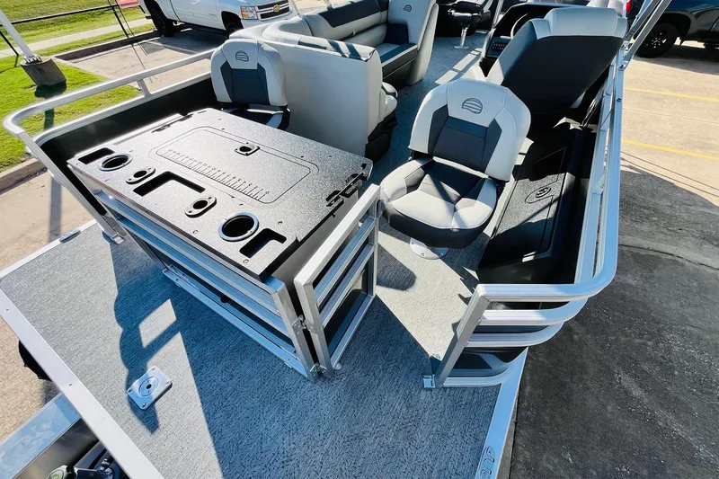 Slide: The Image of 2026 Sun Tracker Fishin' Barge 22 DLX interior with seating and fishing station. - 46