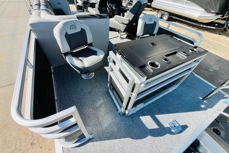 Slide: The Image of 2026 Sun Tracker Fishin' Barge 22 DLX interior with seating and fishing station. - 47