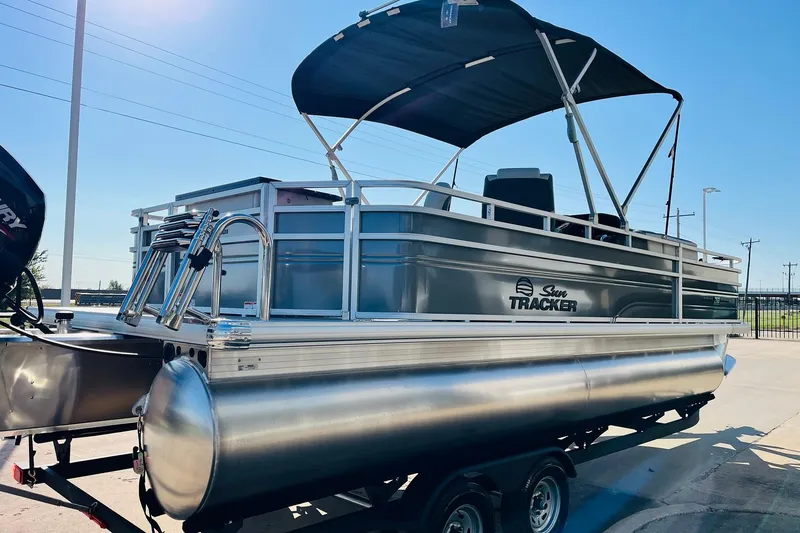 Slide: The Image of 2026 Sun Tracker Fishin' Barge 22 DLX pontoon boat with canopy on trailer. - 5