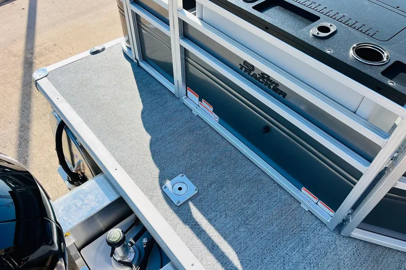 Slide: The Image of 2026 Sun Tracker Fishin' Barge 22 DLX deck with storage and fishing features. - 52