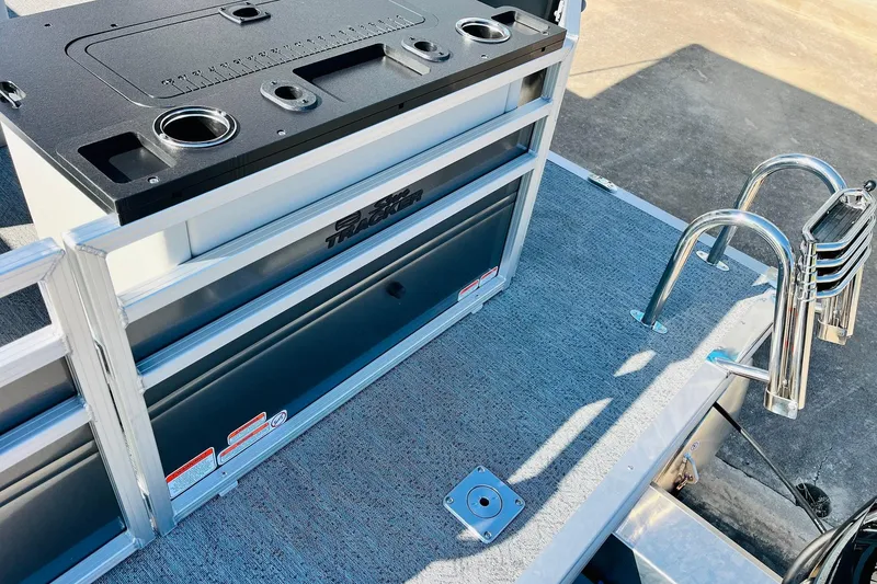 Slide: The Image of 2026 Sun Tracker Fishin' Barge 22 DLX deck with ladder and storage compartments. - 53