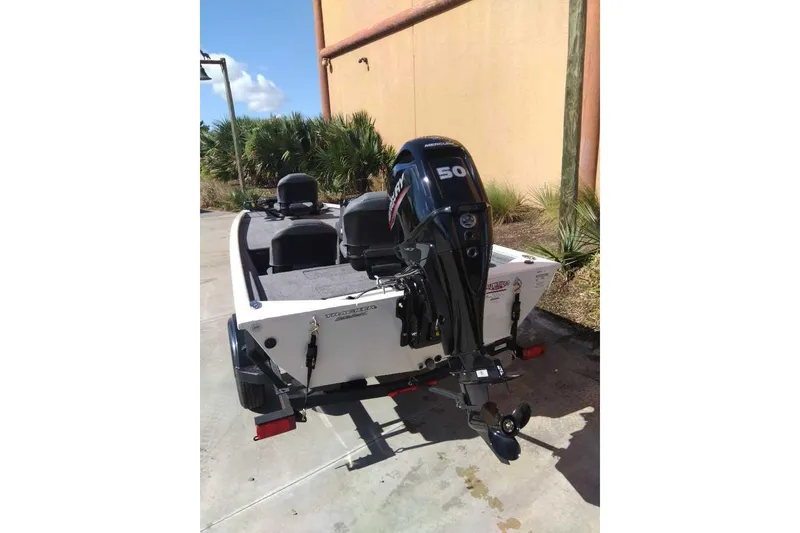 Slide: The Image of 2026 Tracker Pro 170 boat with Mercury 50 HP engine, parked outdoors. - 4