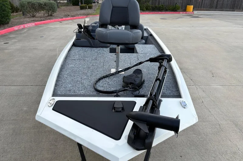 Slide: The Image of 2026 Tracker Pro 170 boat with trolling motor and seating, parked on concrete. - 7