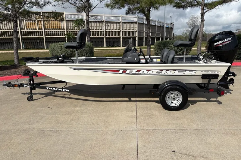 Slide: The Image of 2026 Tracker Pro 170 boat on trailer, featuring Mercury outboard motor, parked outdoors. - 12