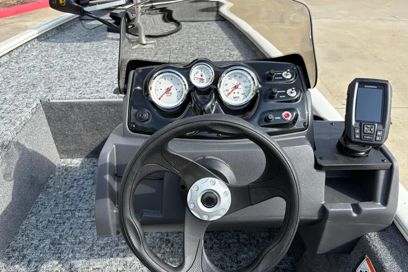 Slide: The Image of 2026 Tracker Pro 170 boat dashboard with steering wheel, gauges, and Garmin device. - 9