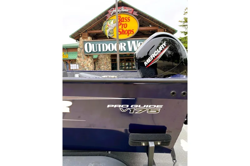 Slide: The Image of 2026 Tracker Pro Guide V-175 WT boat at Bass Pro Shops entrance. - 2