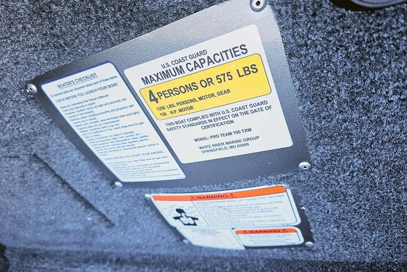 Slide: The Image of Capacity label on 2026 Tracker Pro Team 195 boat, indicating maximum weight and passenger limits. - 10