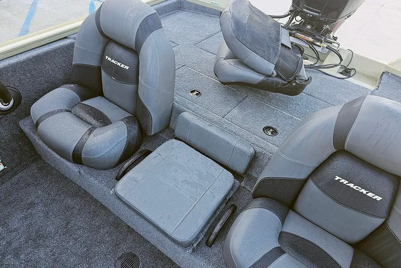 Slide: The Image of 2026 Tracker Pro Team 195 boat interior with cushioned seating and carpeted flooring. - 13