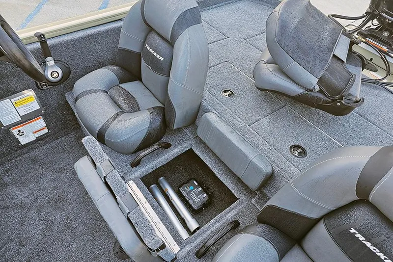 Slide: The Image of Interior of 2026 Tracker Pro Team 195 boat with gray seating and storage compartments. - 14