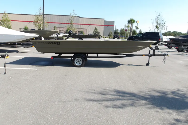The Image of 2026 Tracker Grizzly 1860 Utility boat on trailer in parking lot. - 0