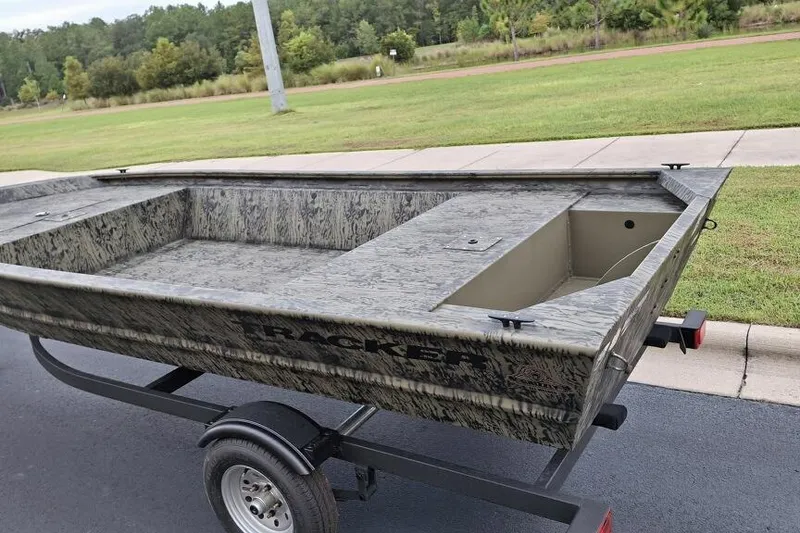 Slide: The Image of 2026 Tracker Grizzly 1648 Utility boat on trailer, parked on roadside. - 3