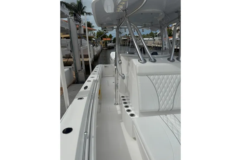 Slide: The Image of 2024 Contender 32 ST boat interior with white seating and rod holders. - 12