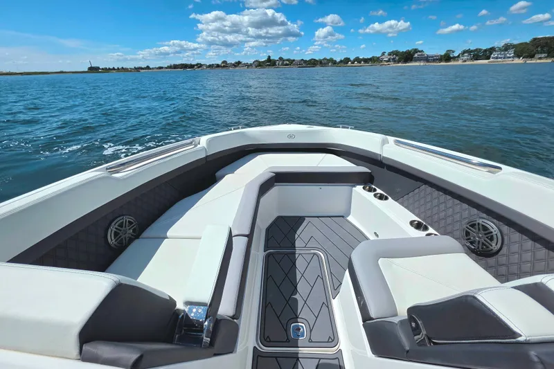 Slide: The Image of 2024 Cobalt R8 Outboard boat interior with luxurious seating on a sunny day. - 16
