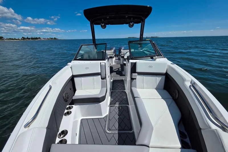 Slide: The Image of 2024 Cobalt R8 Outboard boat interior with luxurious seating on open water. - 19