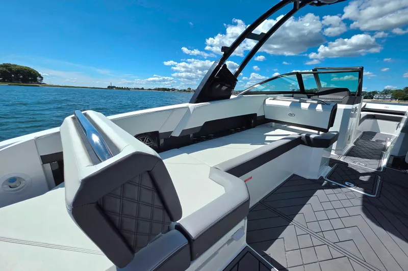 Slide: The Image of 2024 Cobalt R8 Outboard boat interior with sleek seating, on a sunny day by the water. - 22