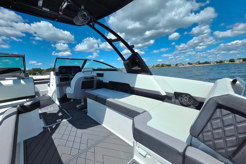 Slide: The Image of 2024 Cobalt R8 Outboard boat interior with sleek seating, modern design, and scenic water view. - 23
