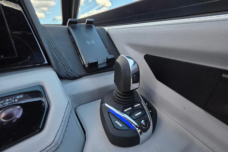 Slide: The Image of 2024 Cobalt R8 Outboard joystick control and phone holder in sleek interior design. - 25