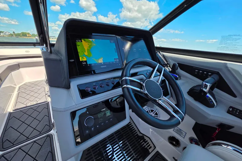 Slide: The Image of 2024 Cobalt R8 Outboard helm with advanced navigation system and sleek steering wheel. - 26