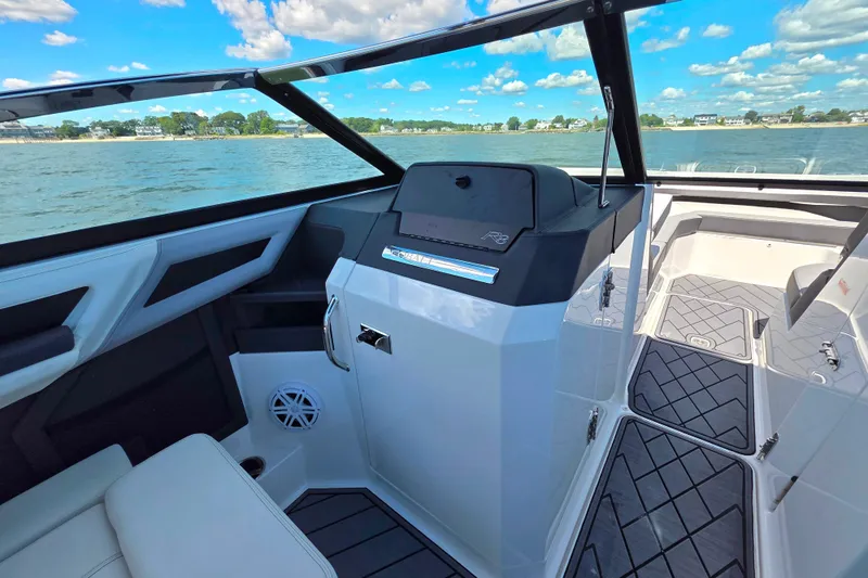 Slide: The Image of 2024 Cobalt R8 Outboard boat interior with sleek design and modern dashboard on a sunny day. - 30