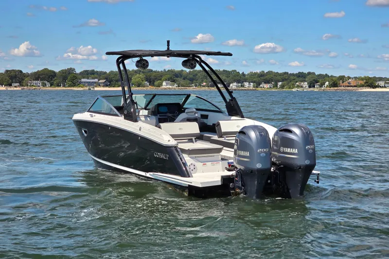 Slide: The Image of 2024 Cobalt R8 Outboard boat with dual Yamaha engines on a sunny lake. - 5