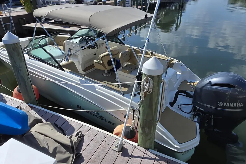 The Image of 2020 NauticStar 223 DC boat docked with Yamaha outboard motor. - 0